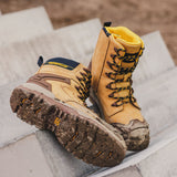 Caterpillar Striver XL S7 tan safety boots showing slip-resistant sole tread with mud