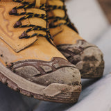 Caterpillar Striver XL S7 tan safety boot close-up showing lace hooks and rubber scuff cap